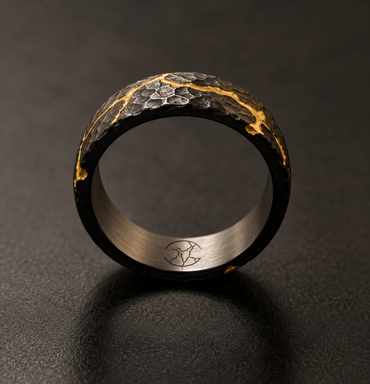 KYNTSU Forged Ring showing fractured black surface and gold PVD detailing